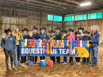 another group picture of team standing behind WVU Western Equestrian Team banner