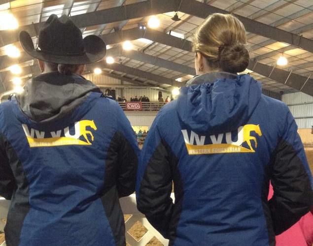 Two members wearing jackets with logo of WVU Western Equestrian club